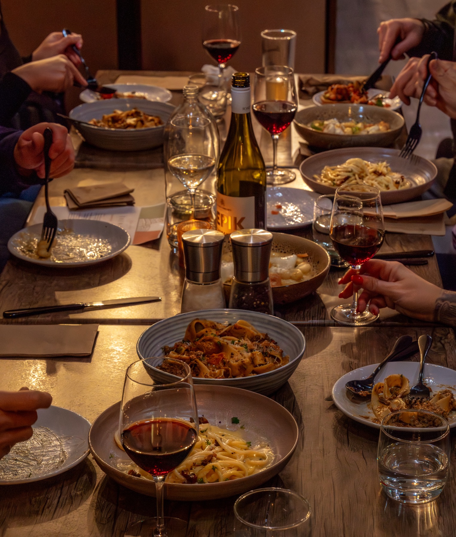 Friends celebrating over dinner at The Wharf
