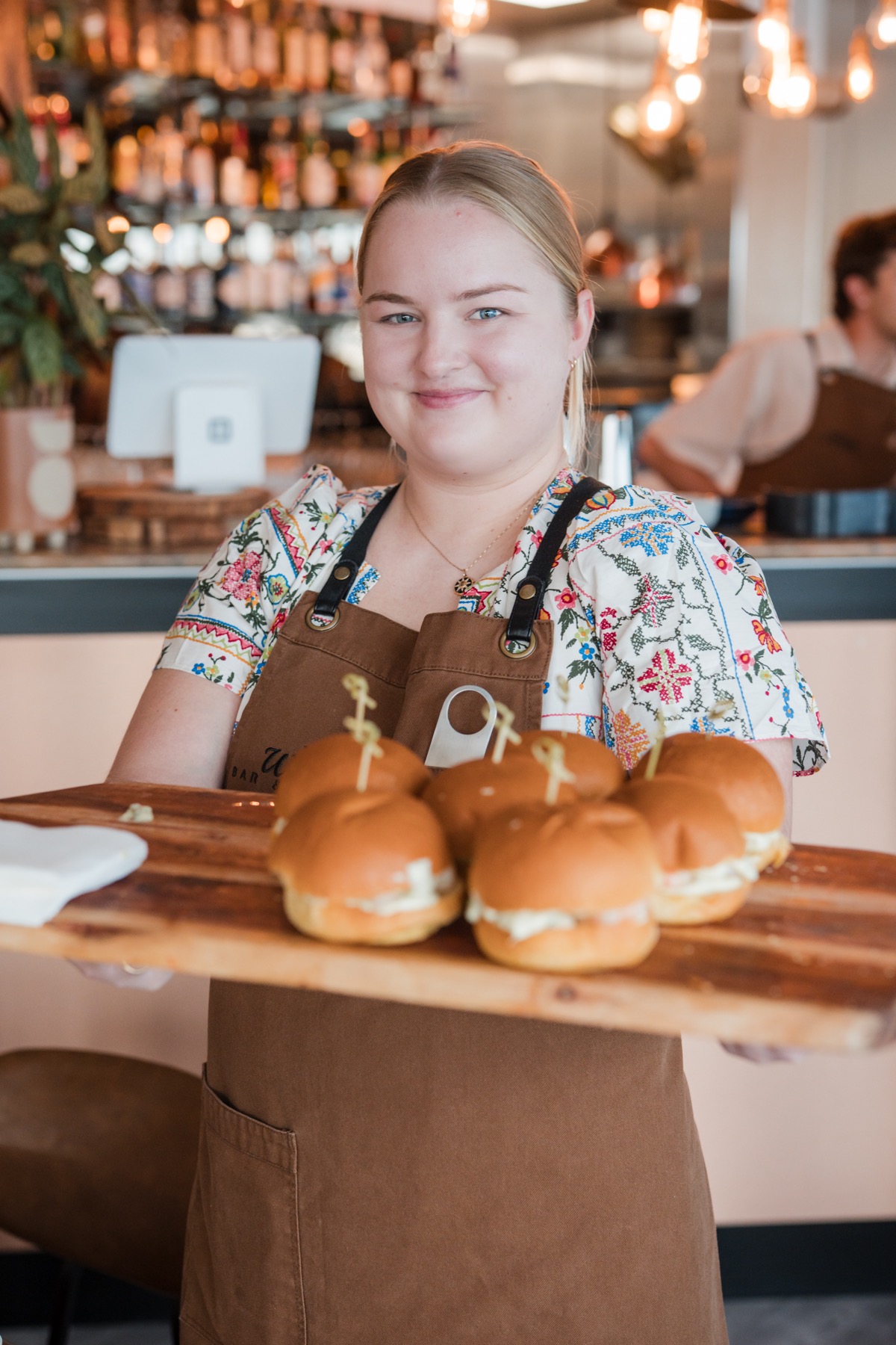 Staff serving sliders at a Wharf event